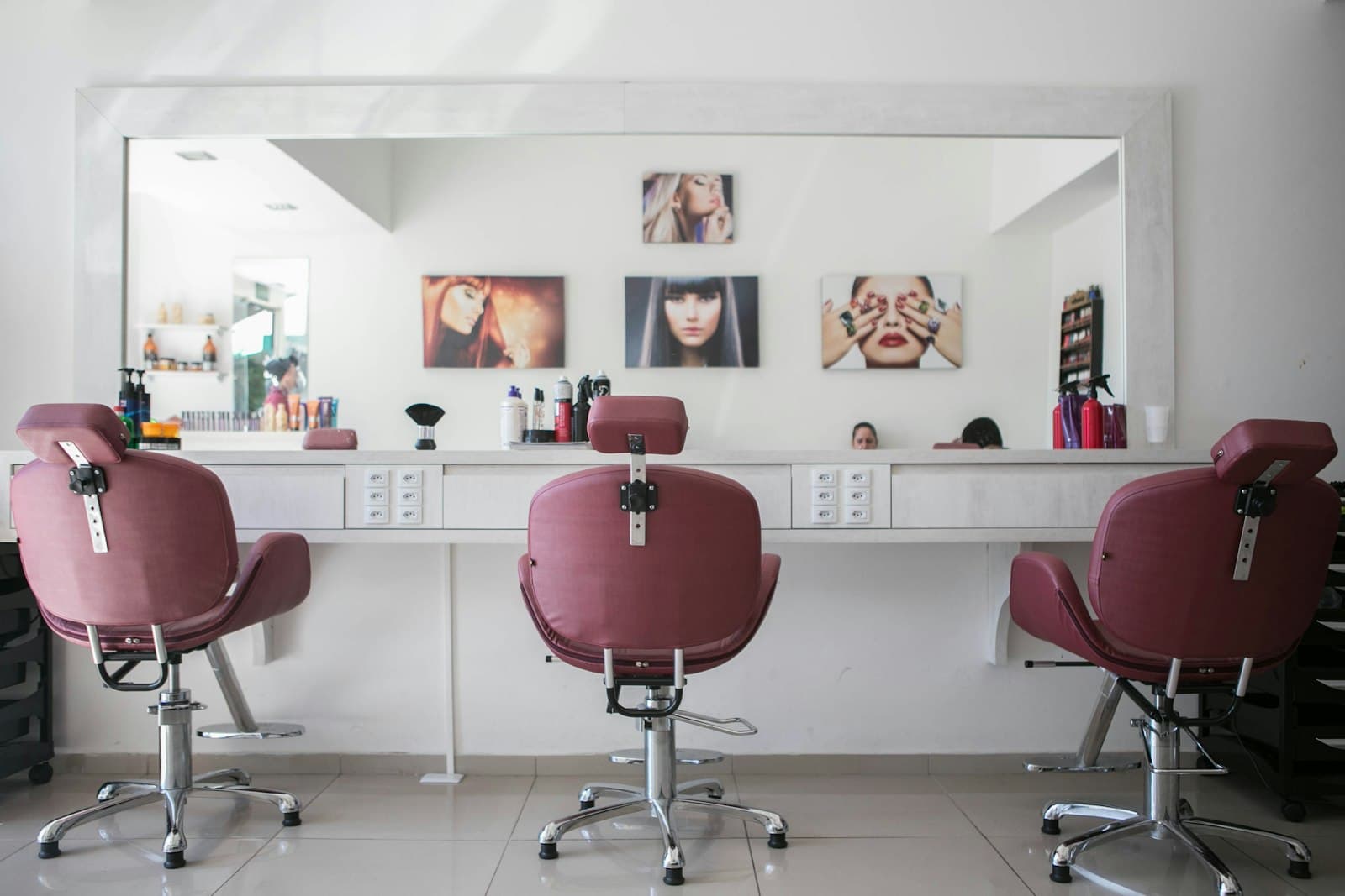Barber shaping hair in a modern chair