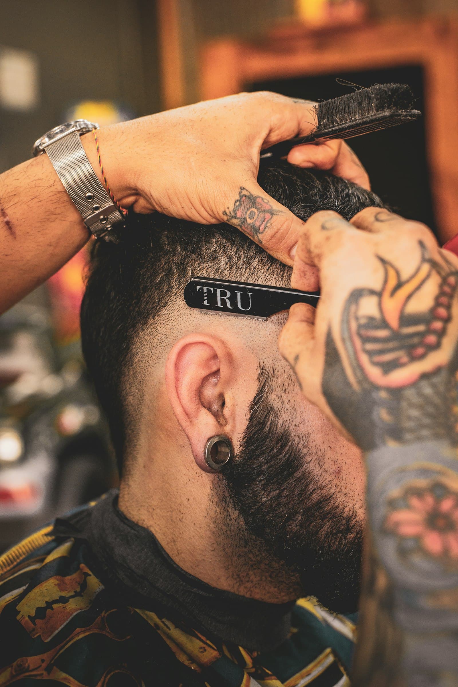 Close-up barber cutting client hair